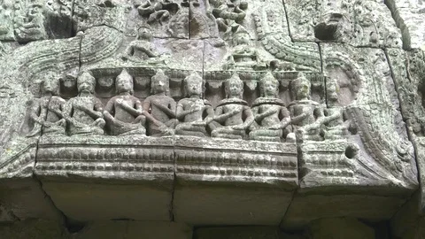 Pan of carved figures on a lintel at ta nei temple, angkor Stock Footage