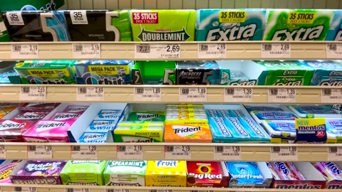 Pan Checkout chewing gum section in a retail grocery store various brands and Stock Footage 175528874