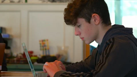 Pan from child to parent doing schoolwork at home Stock Footage 129639757