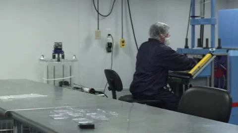 Pan of Cleanroom to Technician Working at Machine Stock Footage 10895888