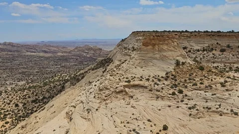 Pan-Cliff face to vast desert scene - Seger's Hole Stock Footage 243840198