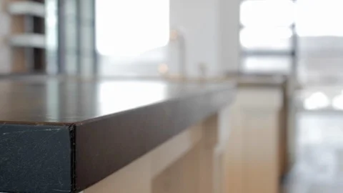 Pan close-up of black soapstone kitchen countertop in modern home. Stock Footage 98013749