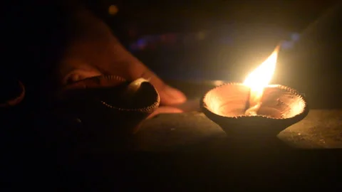 Pan close  shot of lighting diya during Deepawali in India. Video stock 261494995