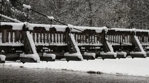Pan of Close up of Snow Covered Rustic Foot Bridge in Woods Stock-Footage 10844328
