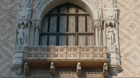 Pan up close up of a statue of a  Doge kneeling the Lion of St Marks on the F Stock Footage 83399880