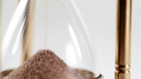 Pan onto close up of traditional sandtimer in brass frame Stock Footage 252520736