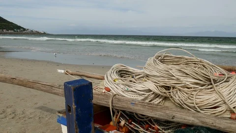 Pan close view of coiled ropes in small beached fishing boat 库存影片 97000629