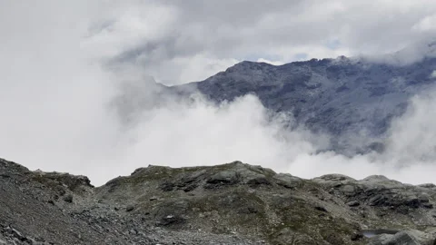 Pan on clouds passing over rocky mountain peak - Italian Alps Stock-Footage 328409248