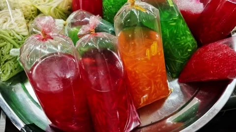 Pan up of colorful local Malay drinks packed in a single use plastic 스톡 동영상 330108486
