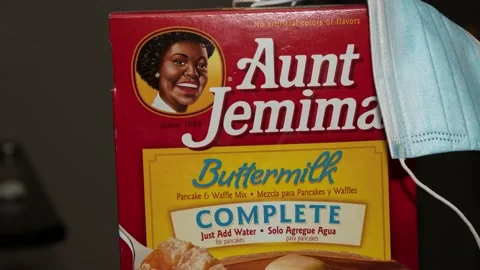 Pan on the controversial Aunt Jemima logo with a Covid-19 mask. 4K Stock Footage 135525504