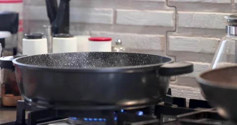 Pan with cooking dish and steam on gas stove Stock Footage 224239458