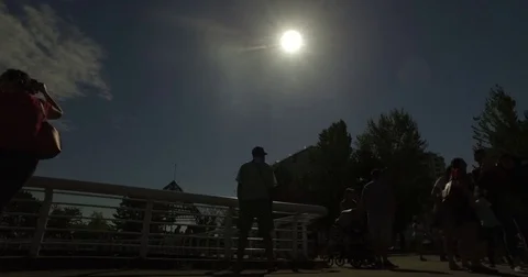 Pan crowd watching solar eclipse at science world Stock Footage 79117942