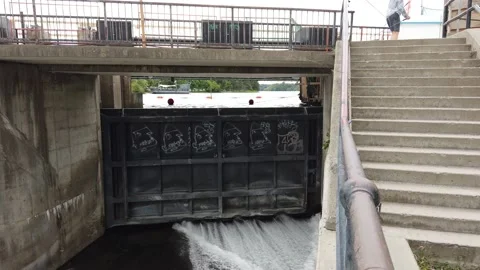 Pan of as dam with a raging river Stock Footage 138650667