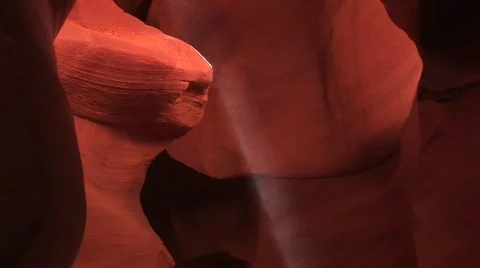 Pan-up of a dancing dust motes in a sunbeam in Antelope Canyon Stock Footage 440517