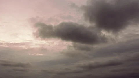 Pan dark ominous storm clouds, dark grey and pink sunrise Stock Footage 195693902