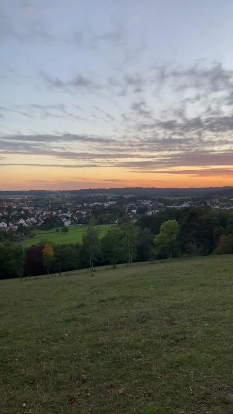 Pan from Distant Castle to City with Sunset Light and Wind Turbines in 4K Video stock 317582550