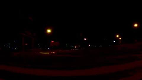 Pan of distant city lights at night and traffic on the on ramp to interstate  Stock Footage 177666196