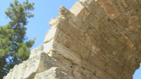 Pan down into ancient city ruins on the island of Delos, Greece Stock Footage 108596330