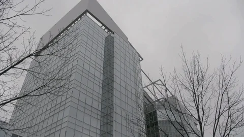 Pan down and to right on mirrored office building in fog winter Stock Footage 89945529