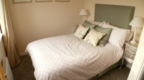 Pan down from bedroom light to bed Stock Footage 35596778