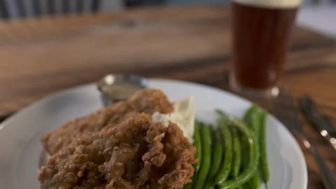 Pan down from beer to fried chicken  動画素材 112575465