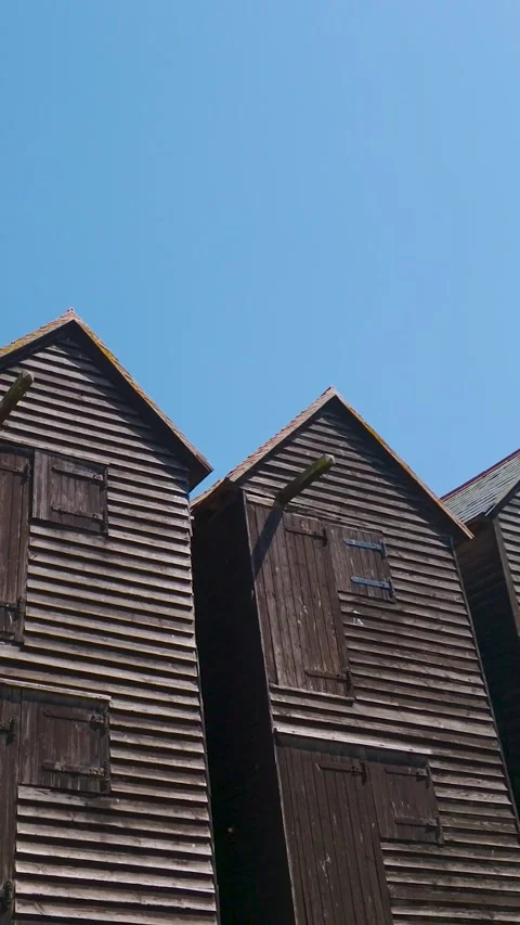 Pan Down From Blue Sky to Hastings Net Shops, Copy Space Above. Vertical Stock Footage 342295230
