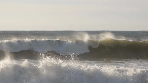 Pan down from blue sky with white clouds to choppy ocean waves Stock Footage 103283329