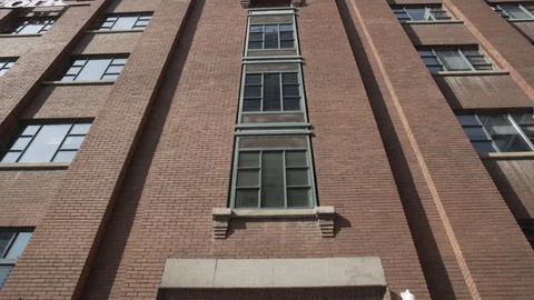 Pan Down Brick Building Glass Entrance Time Lapse Pedestrians Bike Stock Footage 85853712