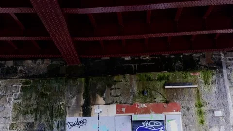 Pan down on a closed store under a railway bridge Video stock 171799479