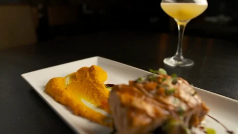 Pan down of cocktail to salmon  動画素材 112575872