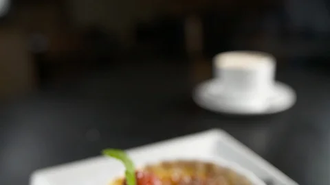 Pan down from coffee to creme brulee  Stock Footage 112575409