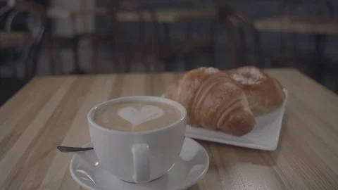 Pan down of coffee with croissants  Stock Footage 112821503