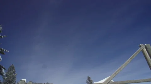 Pan down to a locked gate on a snowy mountain road Stock Footage 47383186