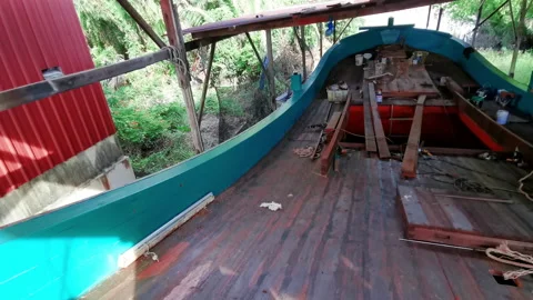 Pan down low light onboard view of a traditional wooden boat under construction. Stock-Footage 140242349