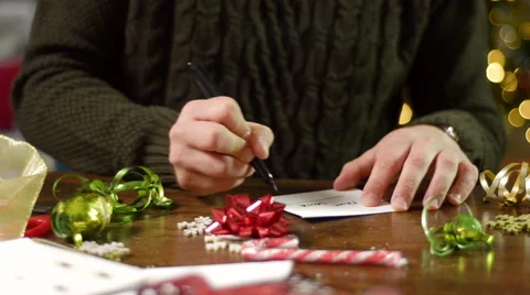 Pan Down From Man Signing Envelope to Candy Canes Stock Footage 56641366