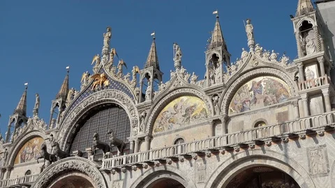 Pan down Medium shot of the facacde of Saint Marks Basilica, St Mark's Square Stock Footage 83389037