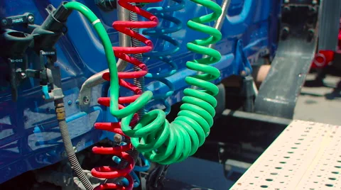 Pan down of multi-colored connecting cables in back of freight liner truck Stock-Footage 60031331