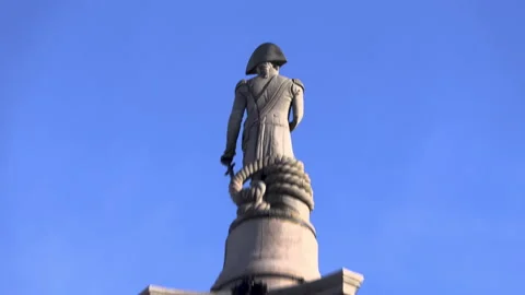 A pan down from Nelson statue to an empty Trafalgar Square during lockdown Stock Footage 142742111