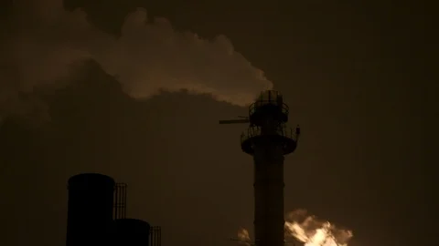 Pan down from night sky to gas flame stack Stock Footage 89945465