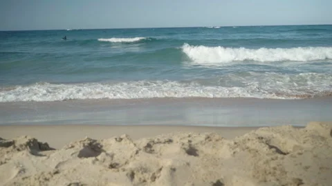 Pan down from the ocean to a pair of flip flops Stock Footage 254795989