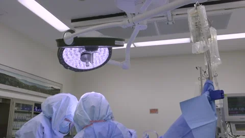 Pan down OR light to surgery 1 Stock Footage 140942501