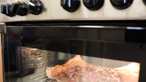Pan Down From Oven Knobs into Pizza Cooking Inside Oven With Mushrooms, 動画素材 109586761