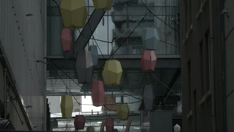 Pan down on paper lanterns in urban alleyway Stock Footage 126791678
