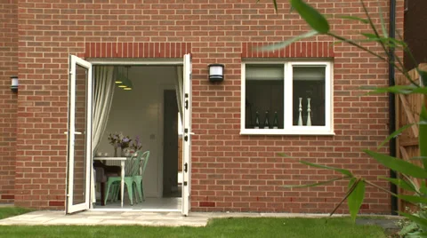 Pan down past Plant of Back Garden House Stock Footage 35596663