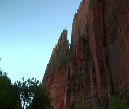 Pan down from redwock cliffs to girls in water Stock Footage 21681449