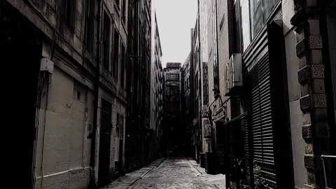 Pan down to reveal dirty old alley in city Stock Footage 160216327