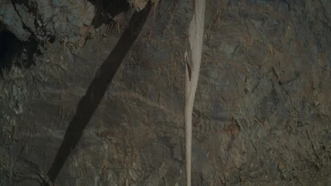 Pan down of a rock formation inside a cave Stock Footage 94957110