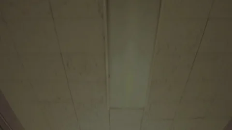 Pan down to roll down hospital hallway - empty white walls Stock Footage 69835394