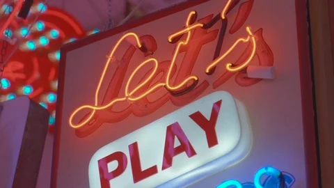Pan down shot of neon sign saying lets play doctors and nurses Stock Footage 100474914