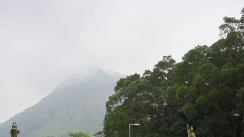 Pan down shot of people walking near Tian Tan Big Buddha statue in Hong kong Stock Footage 91459835